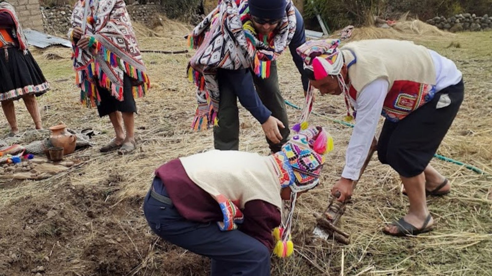Travelers visiting the Tiracancha community and sharing a cultural experience with local families near Cusco